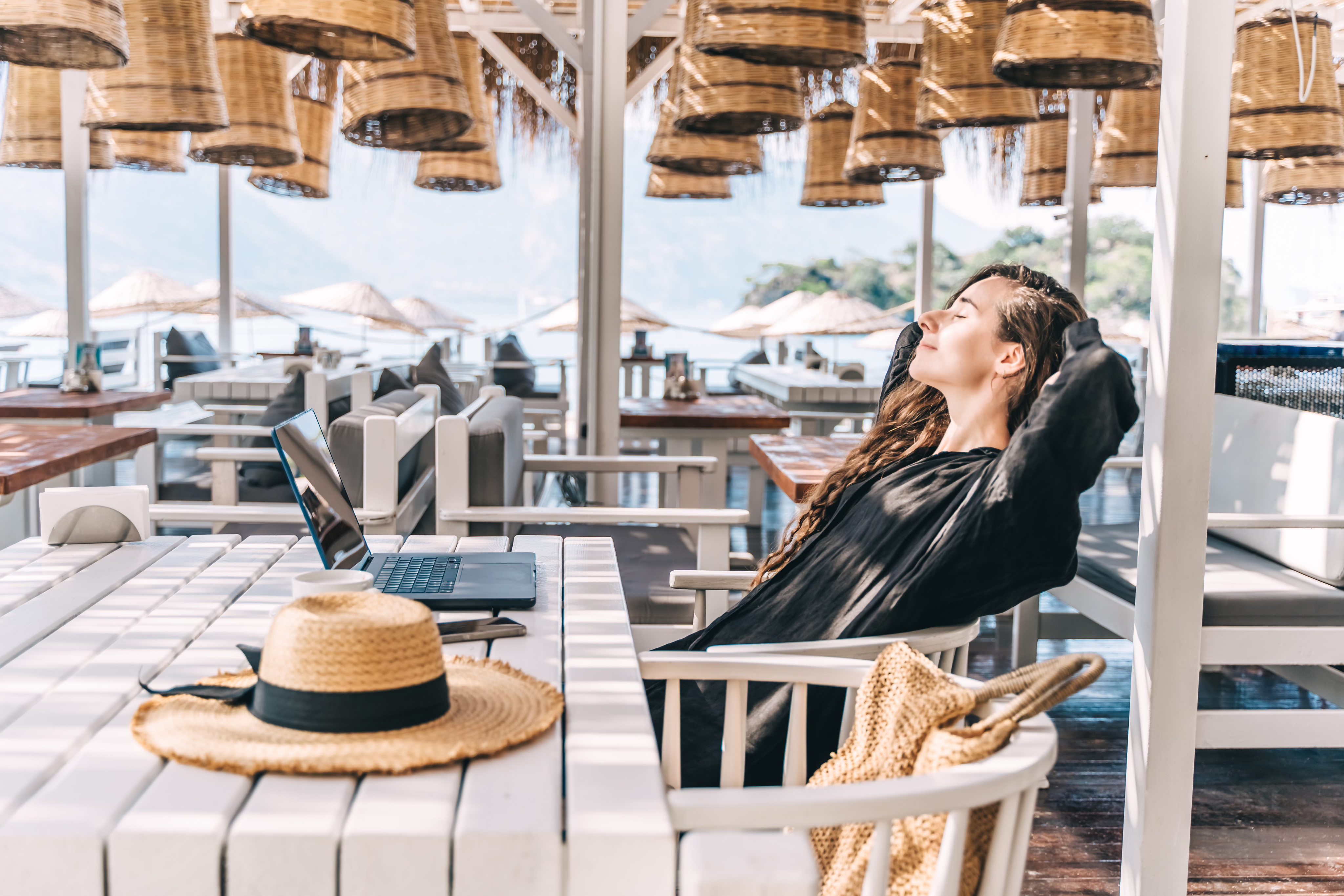 Person working remotely at a beautiful beach location